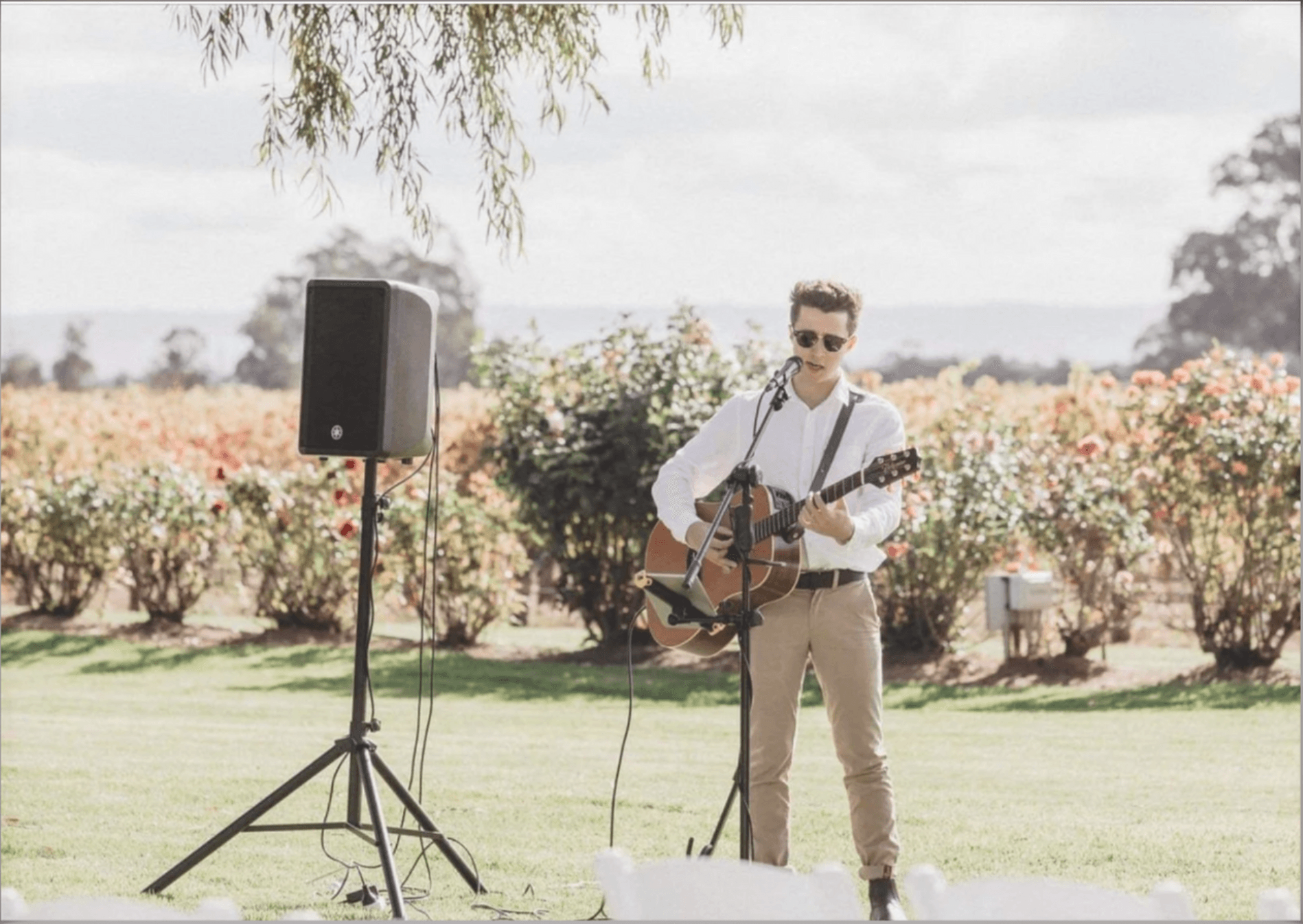 Zac singing and playing acoustic guitar